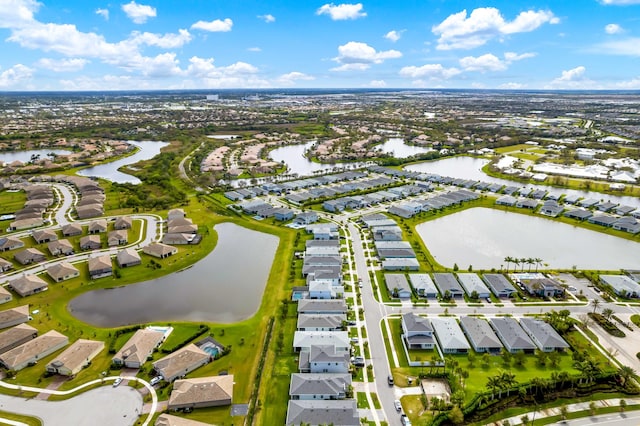 drone / aerial view featuring a residential view and a water view