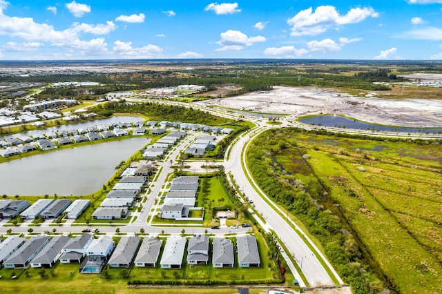 drone / aerial view featuring a water view and a residential view