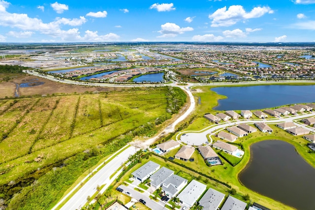 birds eye view of property featuring a water view and a residential view