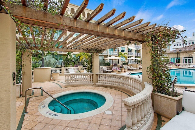 view of swimming pool with a patio area, a pergola, and a hot tub