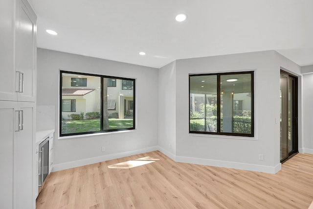 303 Sea Oats Dr Unit D, Juno Beach, FL 33408 - unfurnished living room with light wood-style flooring, recessed lighting, and baseboards