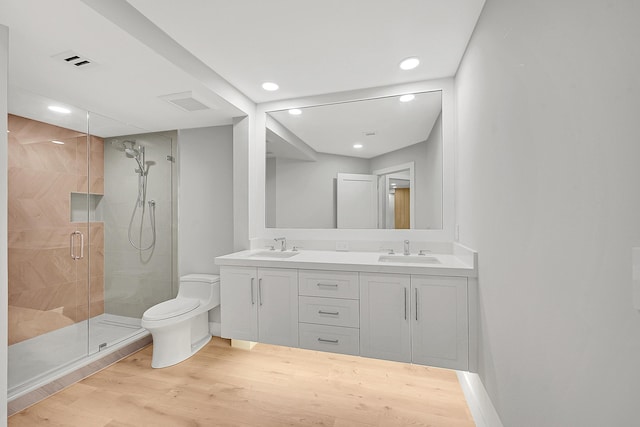 303 Sea Oats Dr Unit D, Juno Beach, FL 33408 - full bath featuring toilet, wood finished floors, a shower stall, recessed lighting, and double vanity