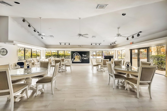 303 Sea Oats Dr Unit D, Juno Beach, FL 33408 - dining area with track lighting, plenty of natural light, lofted ceiling, and a ceiling fan