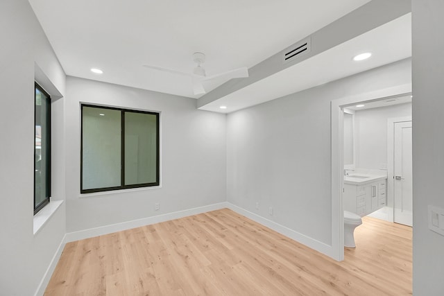 303 Sea Oats Dr Unit D, Juno Beach, FL 33408 - empty room with a sink, light wood finished floors, recessed lighting, and baseboards