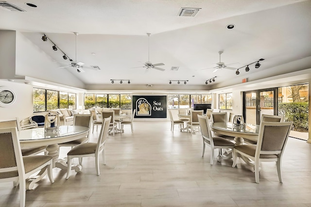 dining area featuring vaulted ceiling, visible vents, and a healthy amount of sunlight