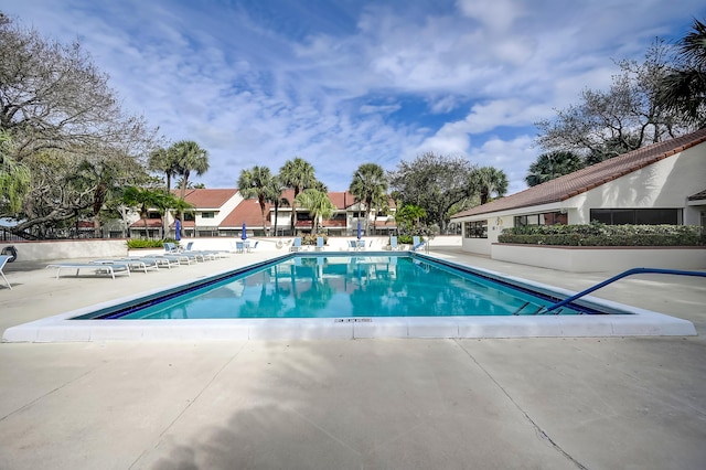303 Sea Oats Dr Unit D, Juno Beach, FL 33408 - community pool with a patio area and fence