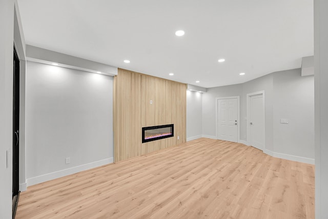 303 Sea Oats Dr Unit D, Juno Beach, FL 33408 - unfurnished living room featuring wood finished floors, recessed lighting, a fireplace, and baseboards