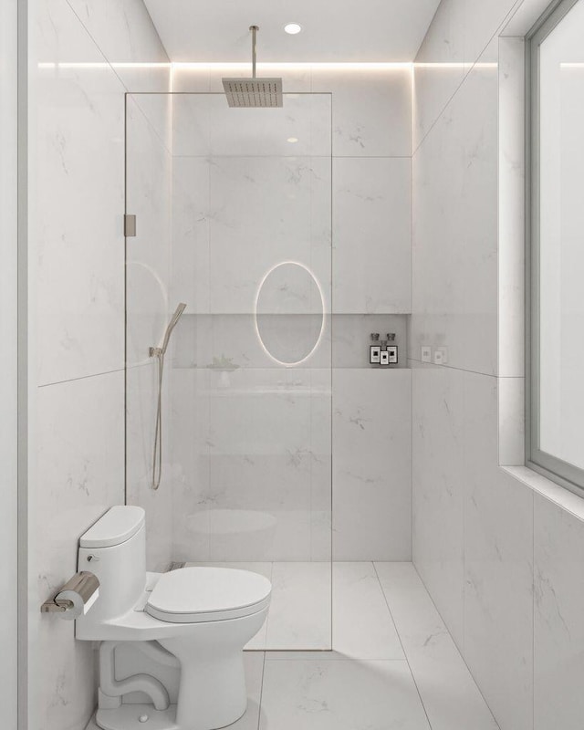 bathroom with a tile shower, tile walls, and toilet