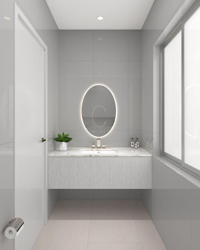 bathroom with sink, tile patterned flooring, and a healthy amount of sunlight