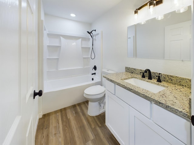 full bathroom featuring tub / shower combination, vanity, toilet, and wood finished floors