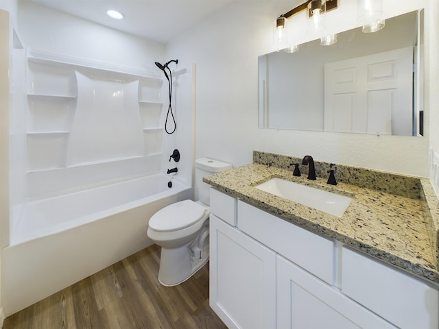 full bathroom featuring shower / bathtub combination, vanity, wood finished floors, and toilet