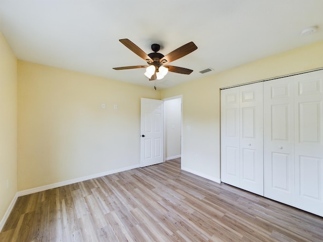 unfurnished bedroom featuring light wood finished floors, baseboards, and visible vents