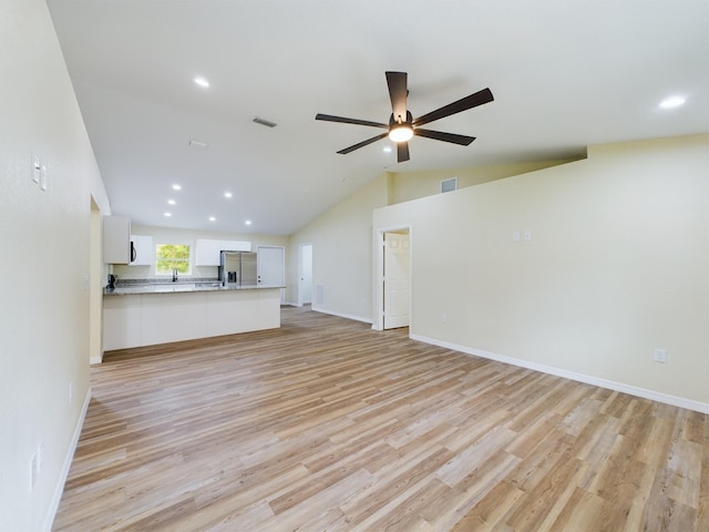 unfurnished living room featuring lofted ceiling, light wood finished floors, visible vents, and a ceiling fan