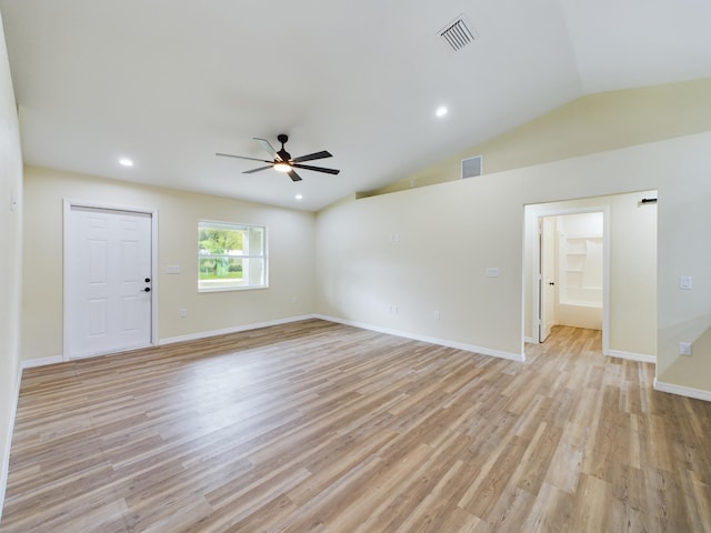 spare room with light wood-type flooring, ceiling fan, visible vents, and vaulted ceiling