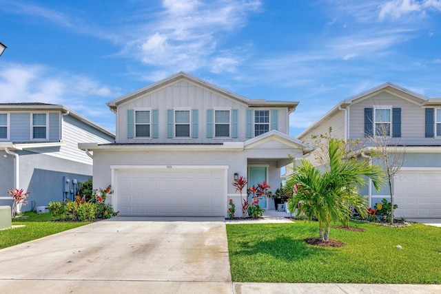 traditional home with an attached garage, driveway, board and batten siding, and a front yard