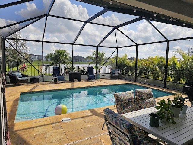 view of swimming pool featuring an outdoor living space, a patio, and glass enclosure