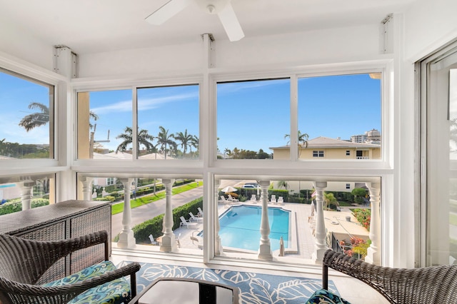 sunroom featuring plenty of natural light and a ceiling fan