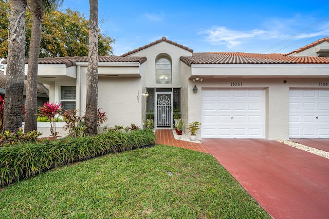 mediterranean / spanish-style house with a front lawn and stucco siding