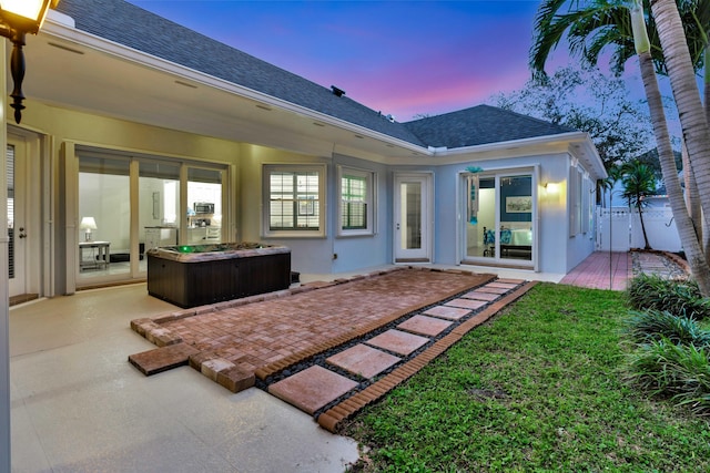 back house at dusk with a patio