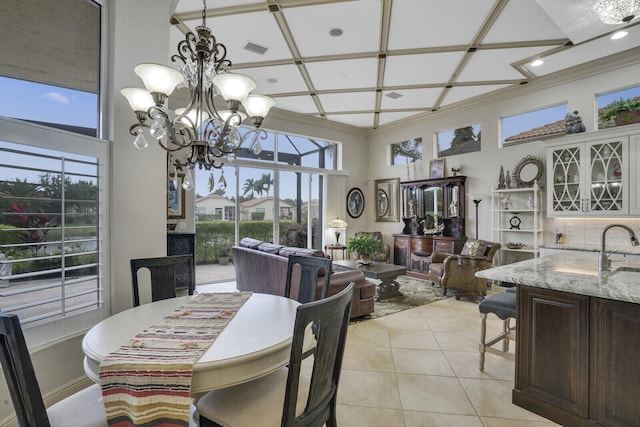 dining space with a chandelier, light tile patterned floors, coffered ceiling, visible vents, and crown molding