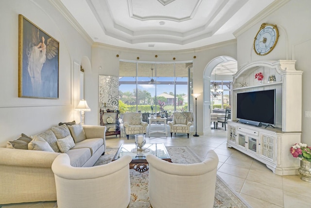 living area with arched walkways, light tile patterned floors, a notable chandelier, ornamental molding, and a tray ceiling