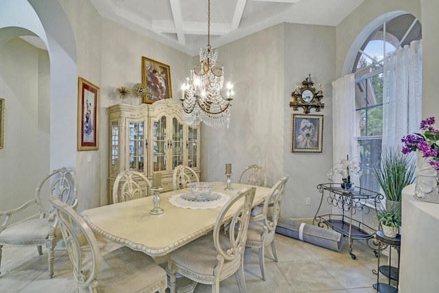 dining room with light tile patterned floors, coffered ceiling, a high ceiling, a chandelier, and beam ceiling