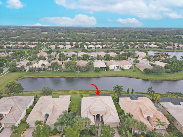 birds eye view of property with a water view and a residential view