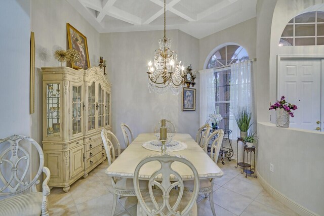 dining area featuring beam ceiling, light tile patterned floors, a chandelier, coffered ceiling, and baseboards