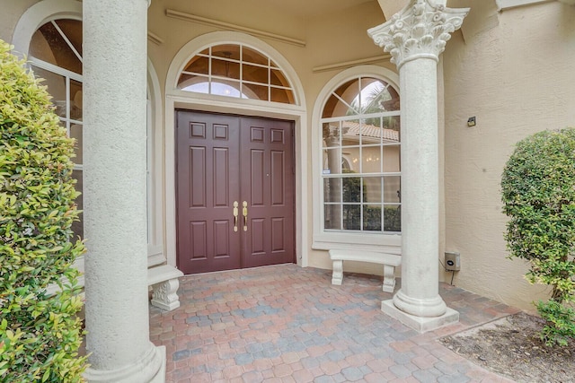 doorway to property with stucco siding