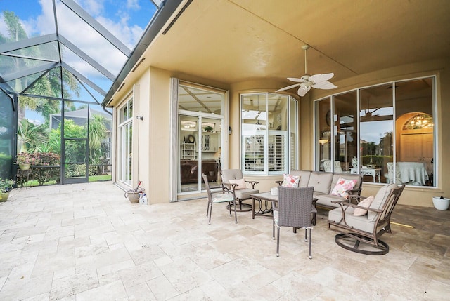 view of patio / terrace with a lanai, ceiling fan, and an outdoor living space