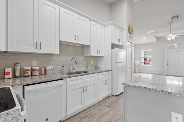 1825 SW Effland Ave, Port Saint Lucie, FL 34953 - kitchen with white appliances, a sink, light wood-type flooring, white cabinetry, and ceiling fan