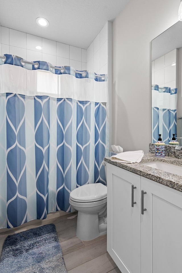 1825 SW Effland Ave, Port Saint Lucie, FL 34953 - full bathroom featuring vanity, toilet, wood finished floors, curtained shower, and recessed lighting