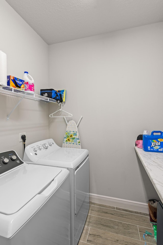 1825 SW Effland Ave, Port Saint Lucie, FL 34953 - laundry room with separate washer and dryer, wood finished floors, and baseboards