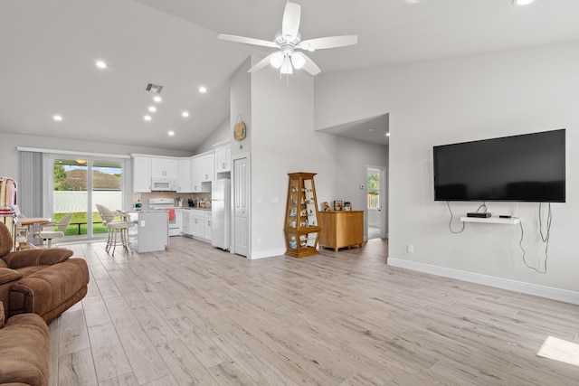 1825 SW Effland Ave, Port Saint Lucie, FL 34953 - living room featuring high vaulted ceiling, light wood-style floors, ceiling fan, recessed lighting, and baseboards
