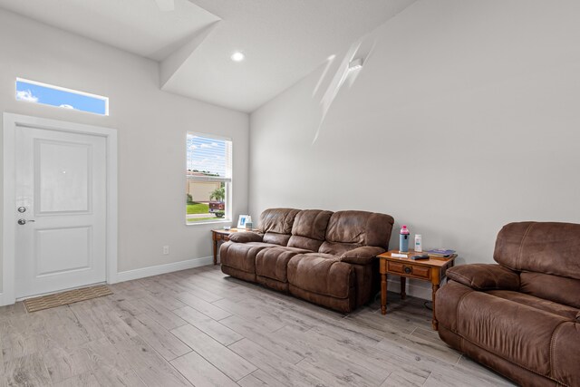 1825 SW Effland Ave, Port Saint Lucie, FL 34953 - living area featuring light wood finished floors, high vaulted ceiling, baseboards, and recessed lighting