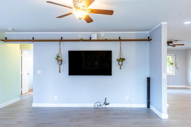 unfurnished living room with light wood-type flooring, ceiling fan, and baseboards