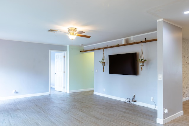 unfurnished living room with light wood-style flooring, visible vents, ceiling fan, and baseboards