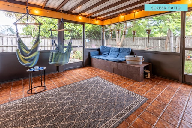 unfurnished sunroom featuring wood ceiling and beam ceiling