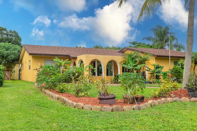 mediterranean / spanish house with a front lawn