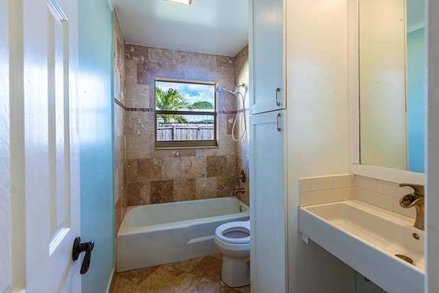 full bathroom with washtub / shower combination, a sink, and toilet