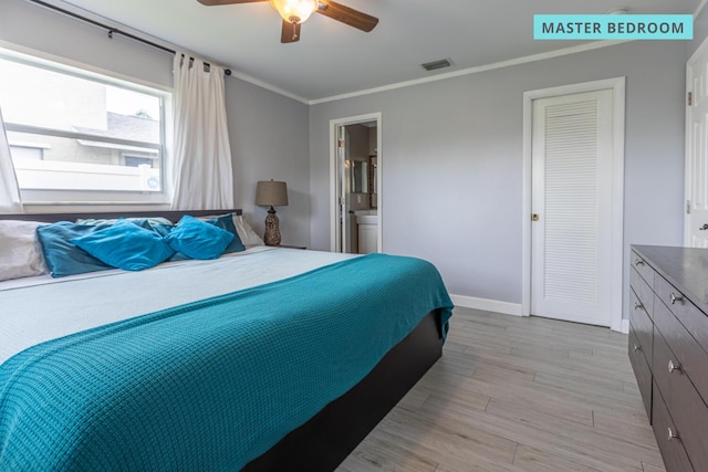 bedroom with light wood-type flooring, ensuite bath, ceiling fan, and ornamental molding