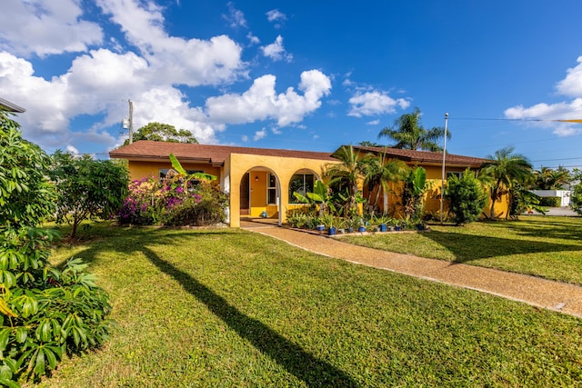 mediterranean / spanish-style house with a front lawn