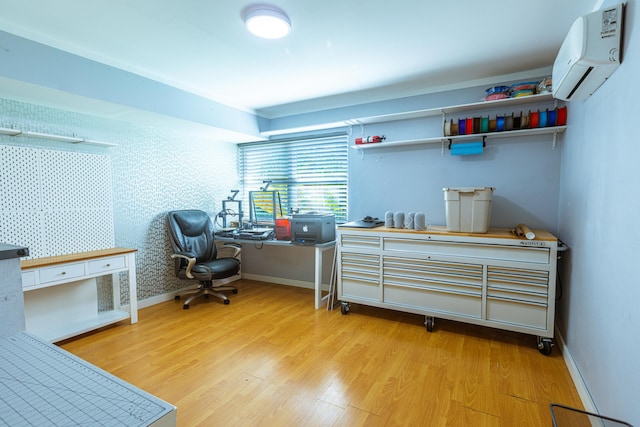 office space featuring wallpapered walls, light wood-style flooring, baseboards, and an AC wall unit