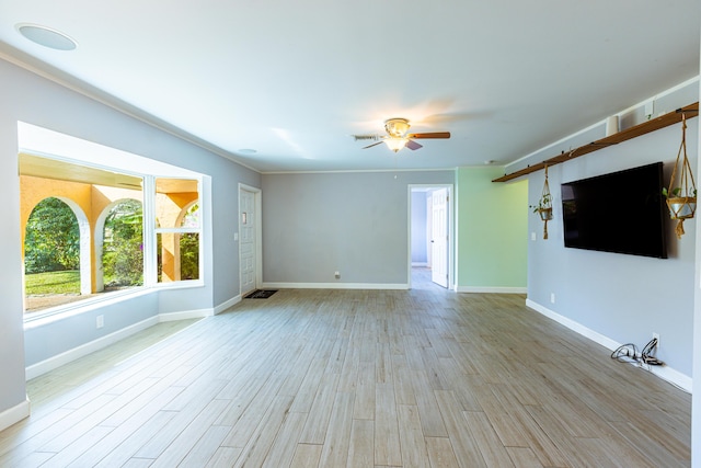 interior space featuring ceiling fan, light wood-type flooring, visible vents, and baseboards