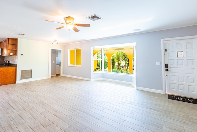 unfurnished living room featuring light wood-style floors, visible vents, and baseboards