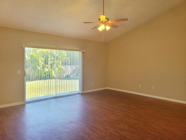 spare room with baseboards, a ceiling fan, dark wood-style flooring, vaulted ceiling, and a textured ceiling