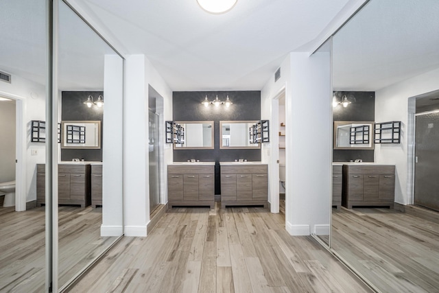 full bath featuring visible vents, a stall shower, wood finished floors, and toilet