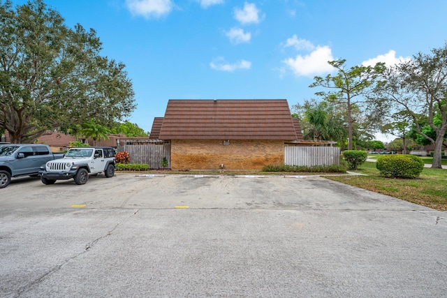 uncovered parking lot featuring fence