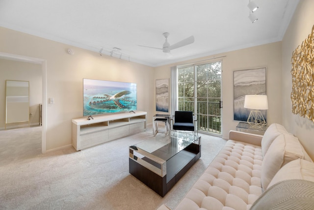 carpeted living room featuring crown molding, ceiling fan, and track lighting