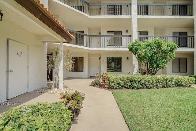 doorway to property featuring stucco siding